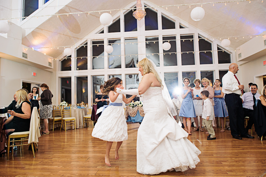 Bride dancing with flowergirl