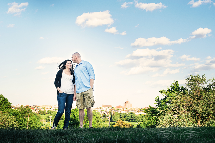 engaged couple standing on a hill in Patterson Park