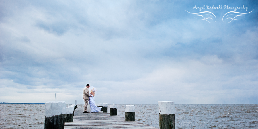 just married couple standing on a dock at Celebrations at the Bay