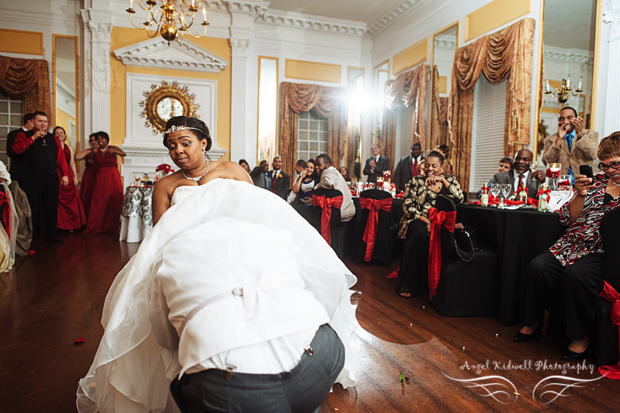 fun Baltimore wedding photography of groom retrieving the garter at grey rock mansion