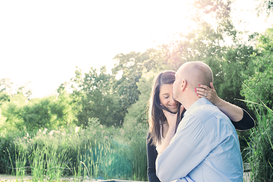 groom kissing bride to be at patterson park in baltimore md