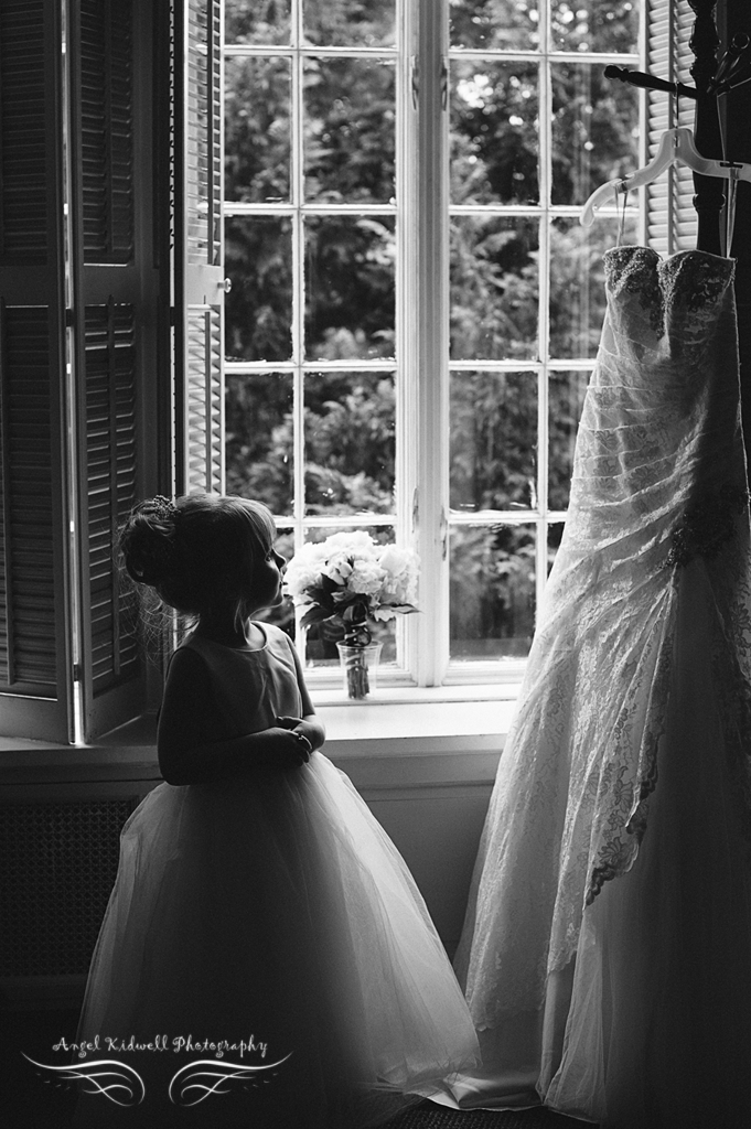 flower girl looking at brides wedding dress at grey rock mansion