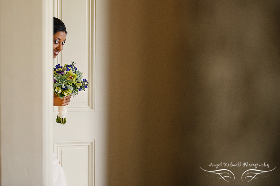 bride peeking around the corner before the wedding at the tudor place