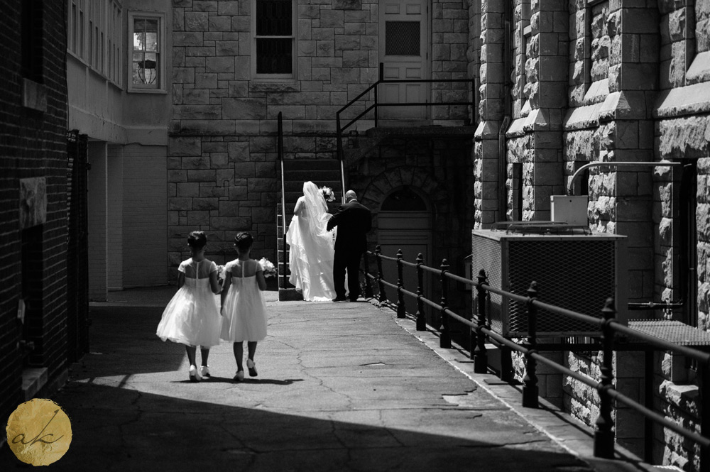 Dramatic black and white photo as the bride and groom slip away at this Washington DC church wedding