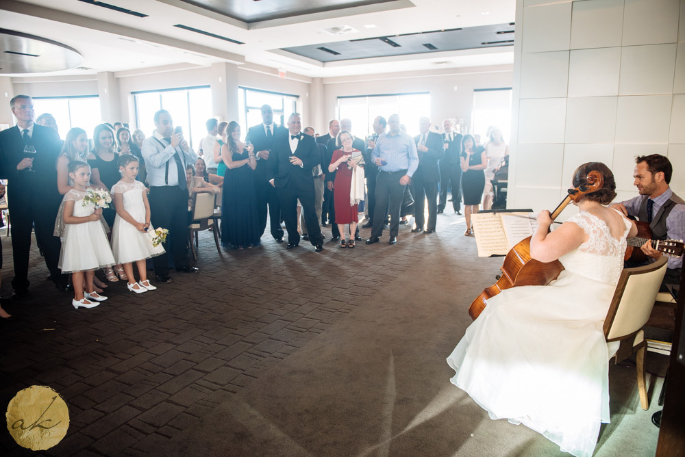 bride playing her cello for the wedding guests at Sunset room National harbor wedding