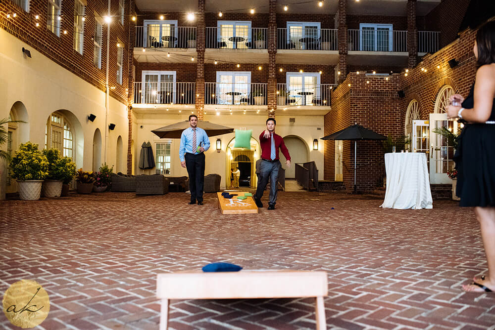 guests playing cornhole at The Alexandrian hotel wedding