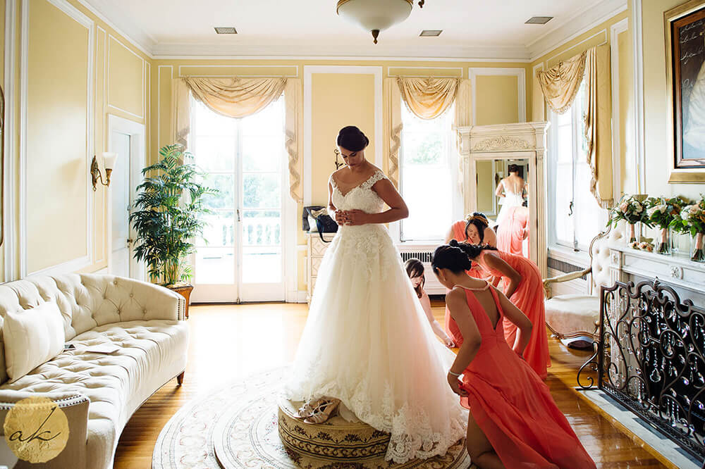 bride getting dressed at Oxon Hill Manor wedding 41