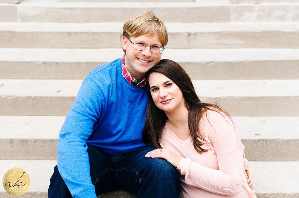 university of maryland spring engagement session couple sitting on steps leaning into each other