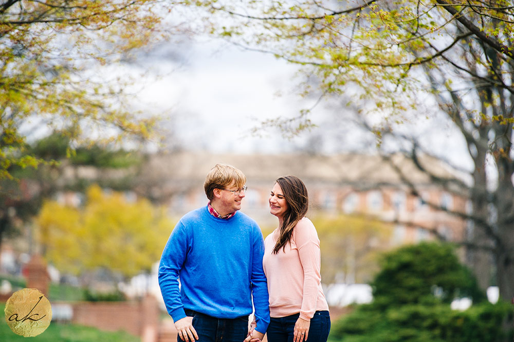 university of maryland spring engagement session couple leaning into each other holding hands