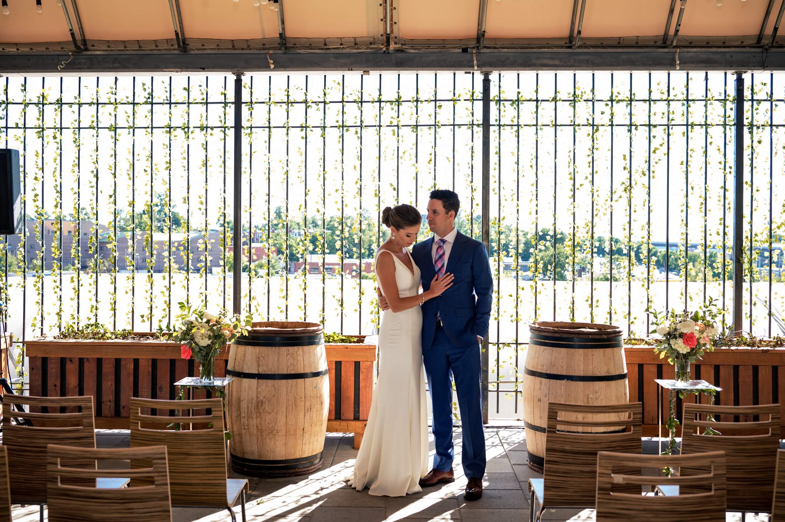 bride and groom standing in front of ivy wall at washington dc winery wedding venue