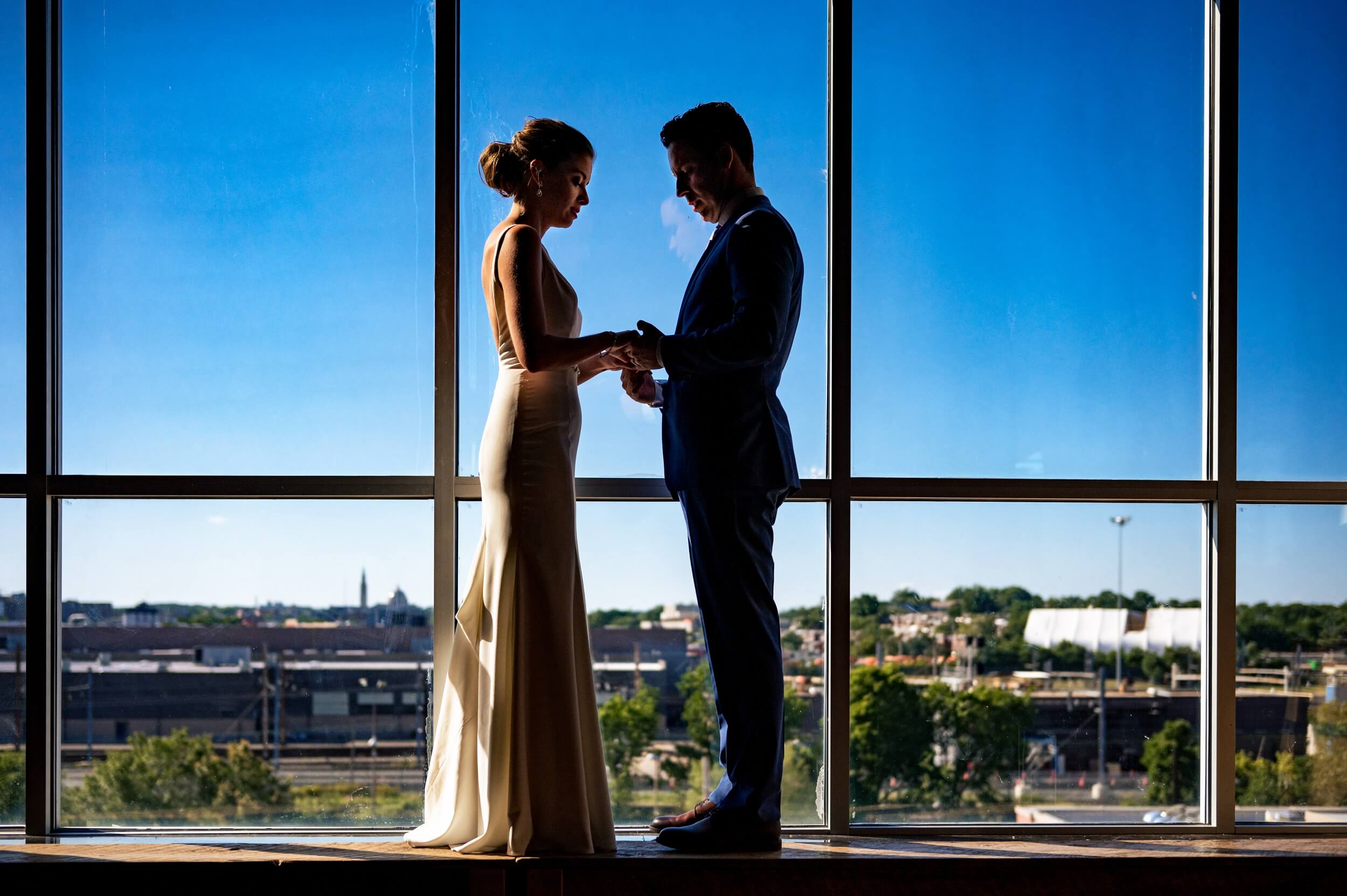 bride and groom standing in front of a window at a washington dc winery wedding venue