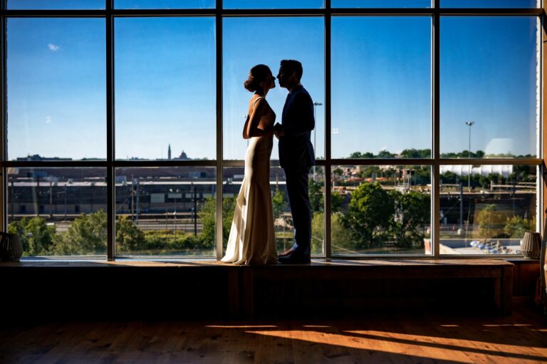 bride and groom standing in front of a window at a washington dc winery wedding venue