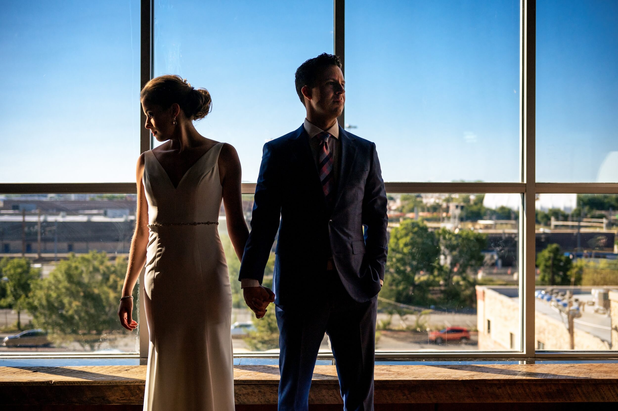 bride and groom standing in front of a window at a washington dc winery wedding venue