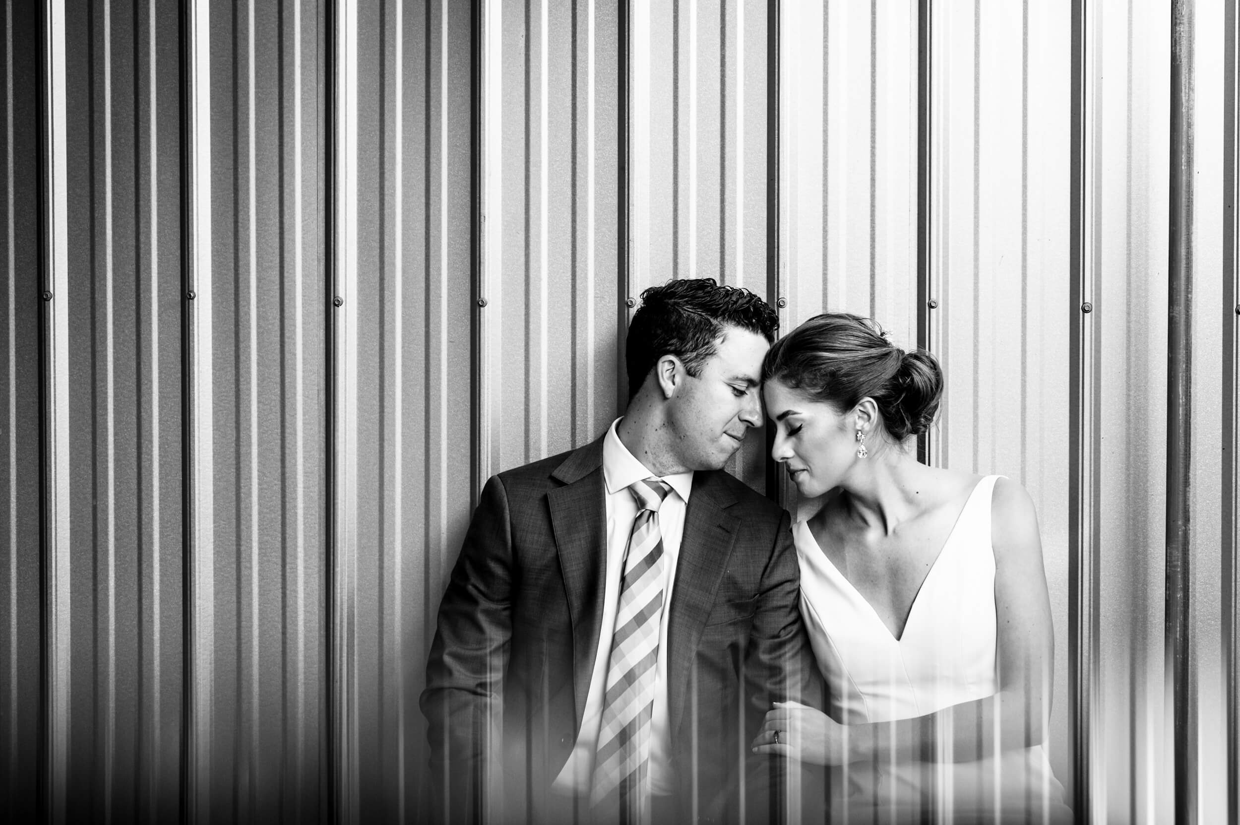 bride and groom leaning into eachother at industrial washington dc wedding venue