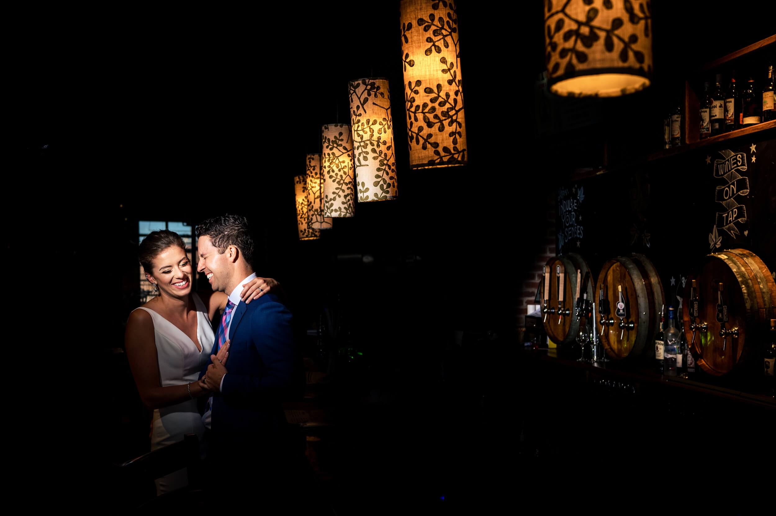 bride and groom laughing at the bar of washington dc winery wedding venue