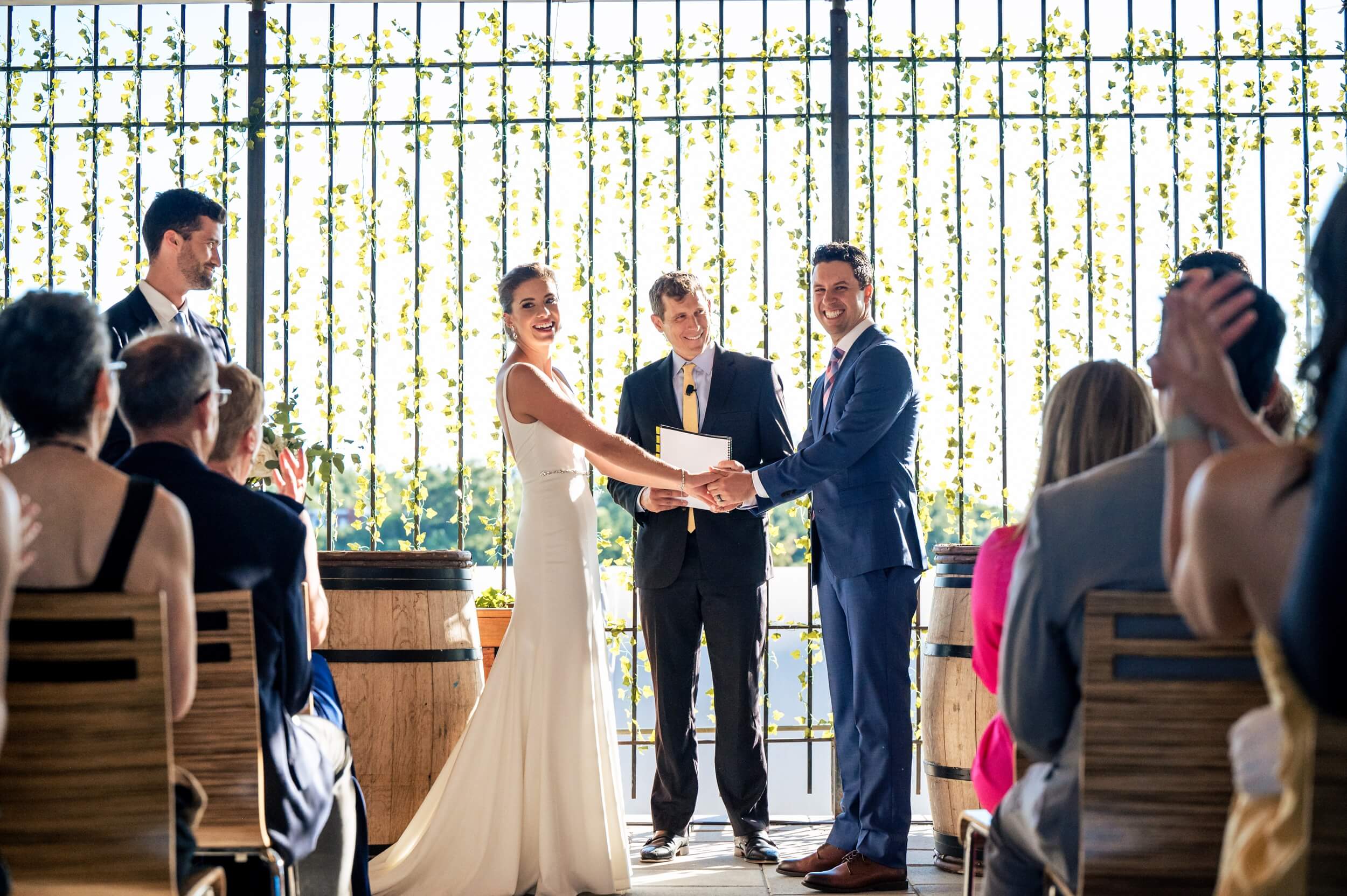 bride and groom standing in front of ivy wall during ceremony at washington dc wedding