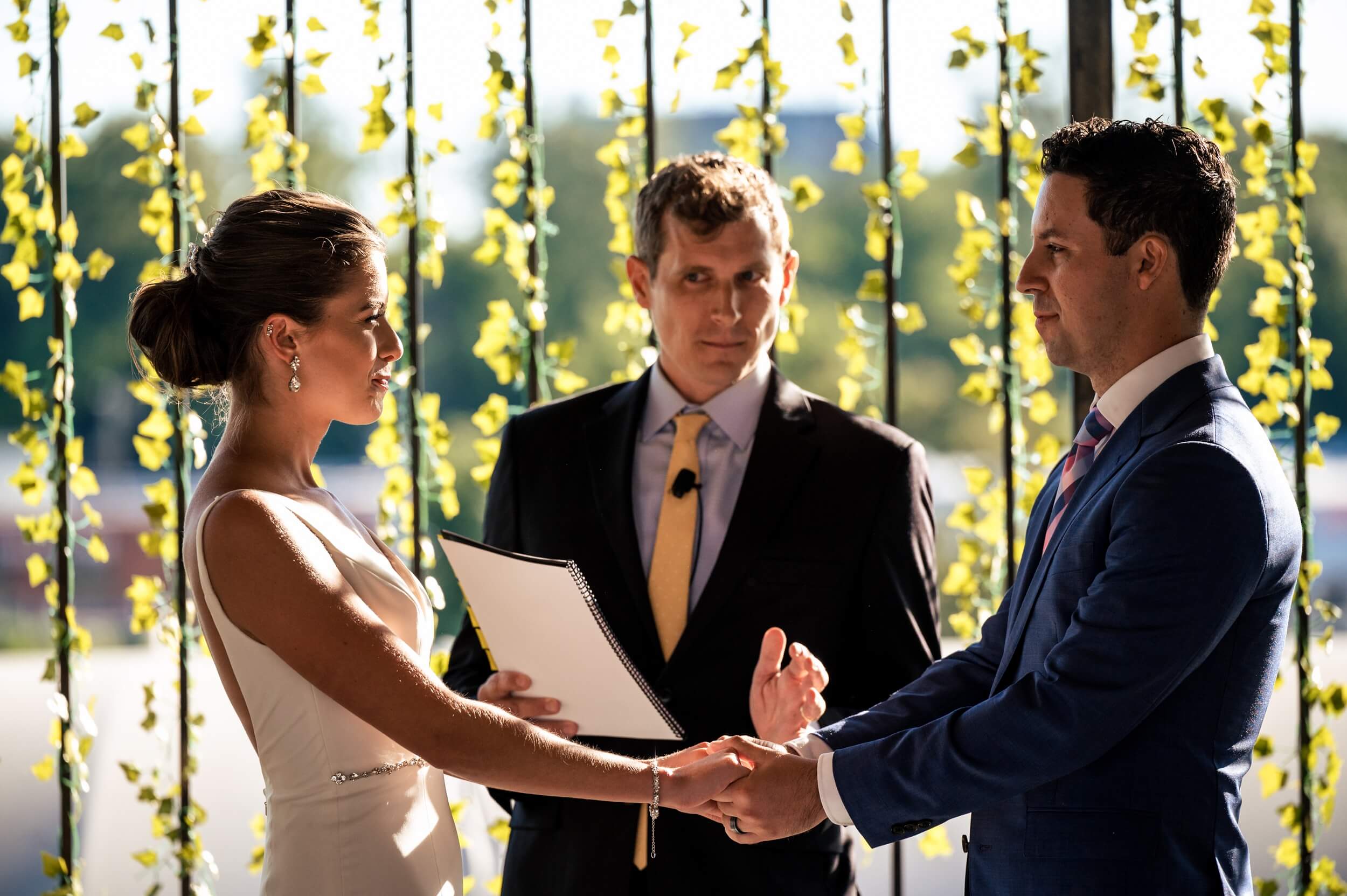 bride and groom standing in front of ivy wall during ceremony at washington dc wedding