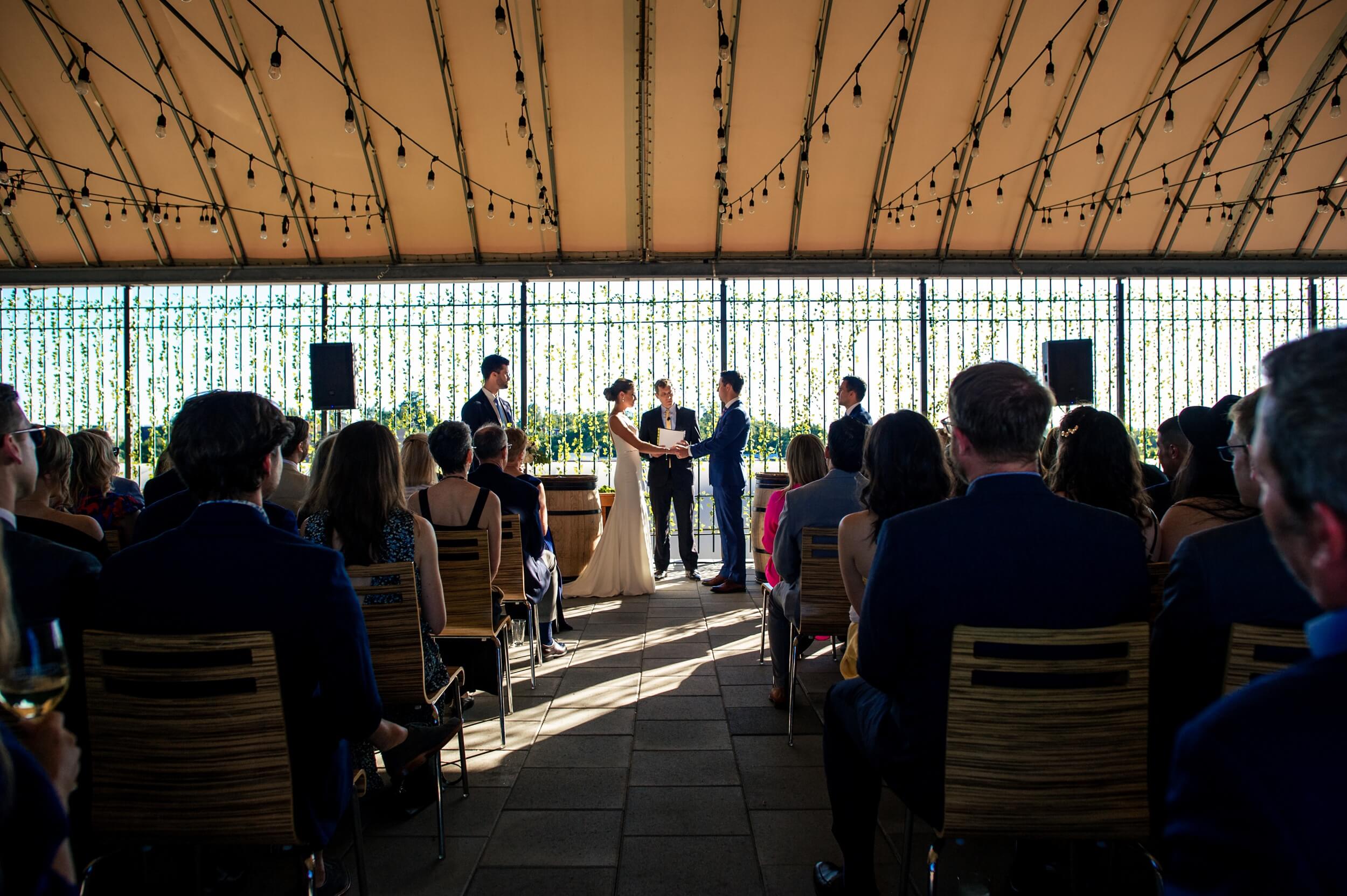 bride and groom standing in front of ivy wall during ceremony at washington dc wedding