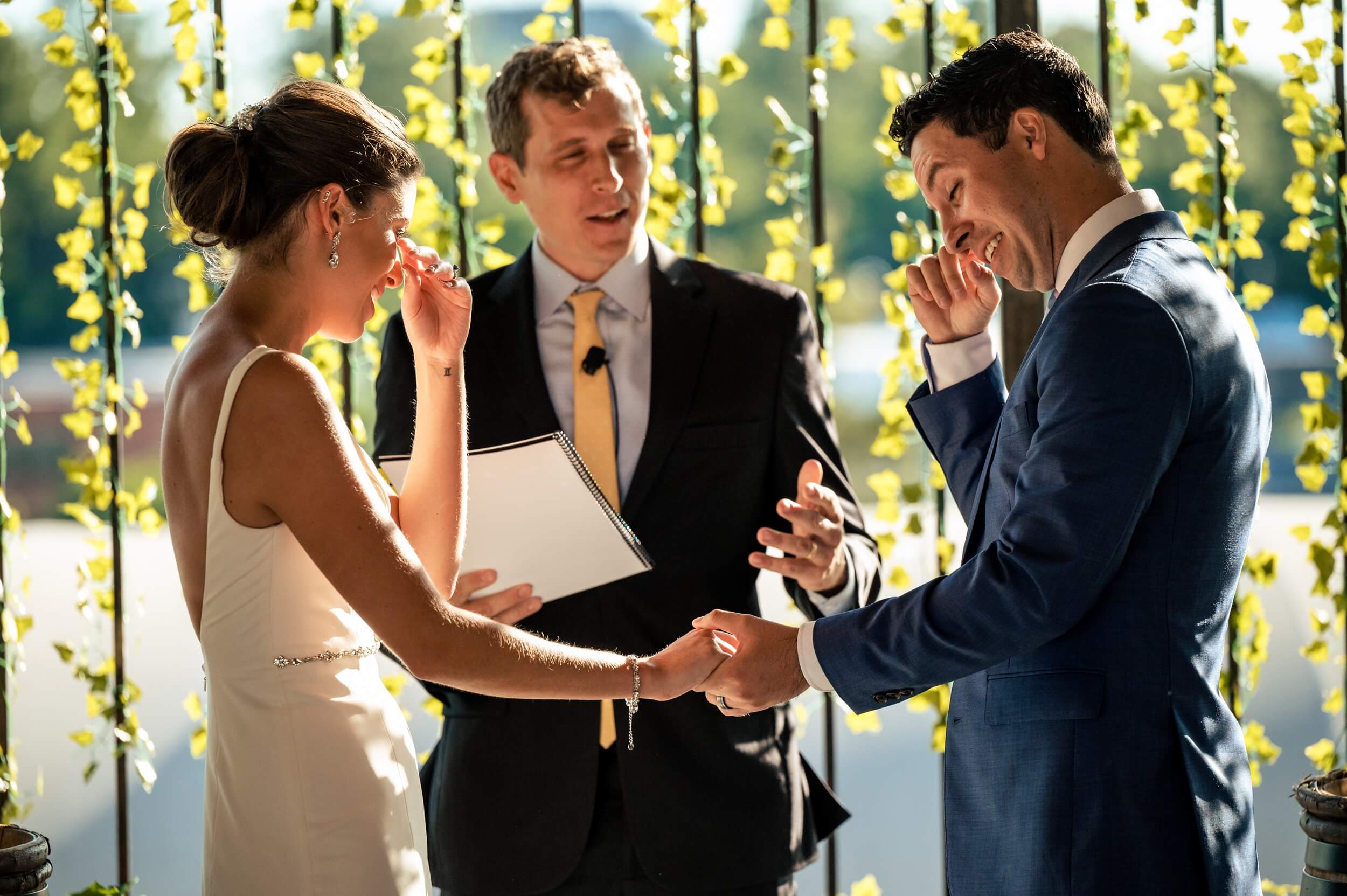 bride and groom wipe tears away during ceremony at washington dc winery wedding