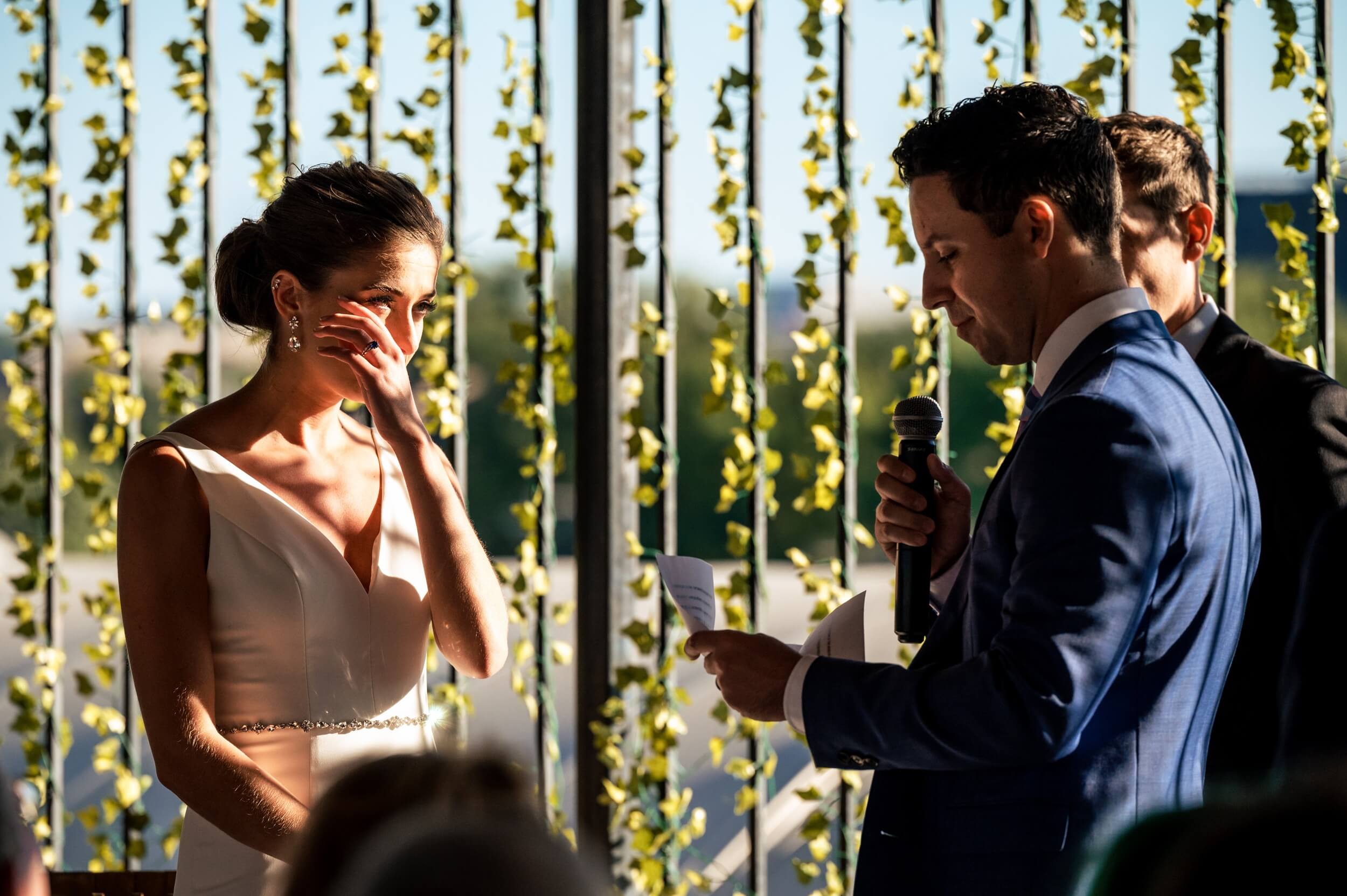 bride wipes tear away as groom reads his vows at washington dc wedding