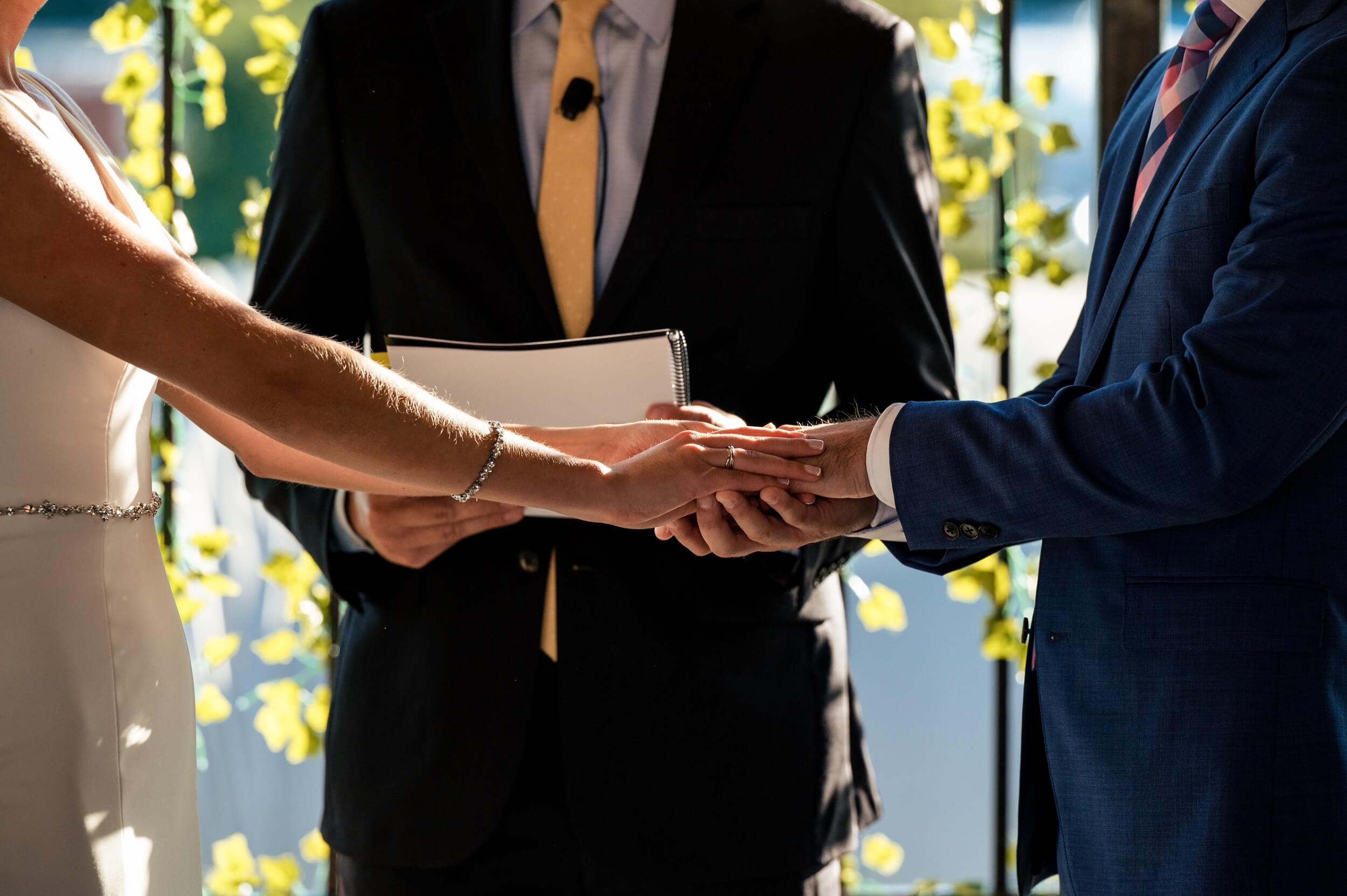 couple holding hands during wedding ceremony in washington dc