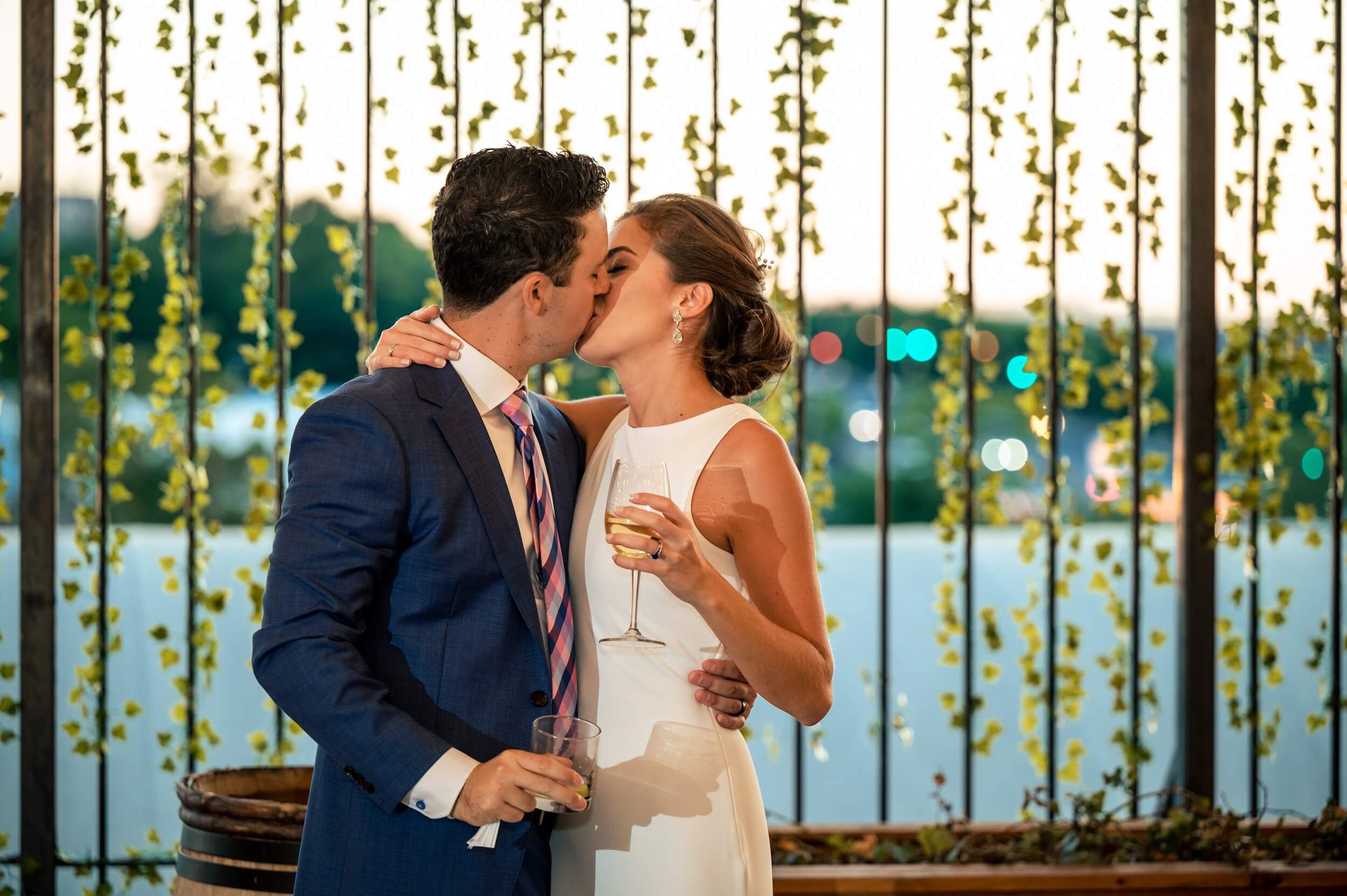 bride and groom kiss at their washington dc winery wedding during reception speeches