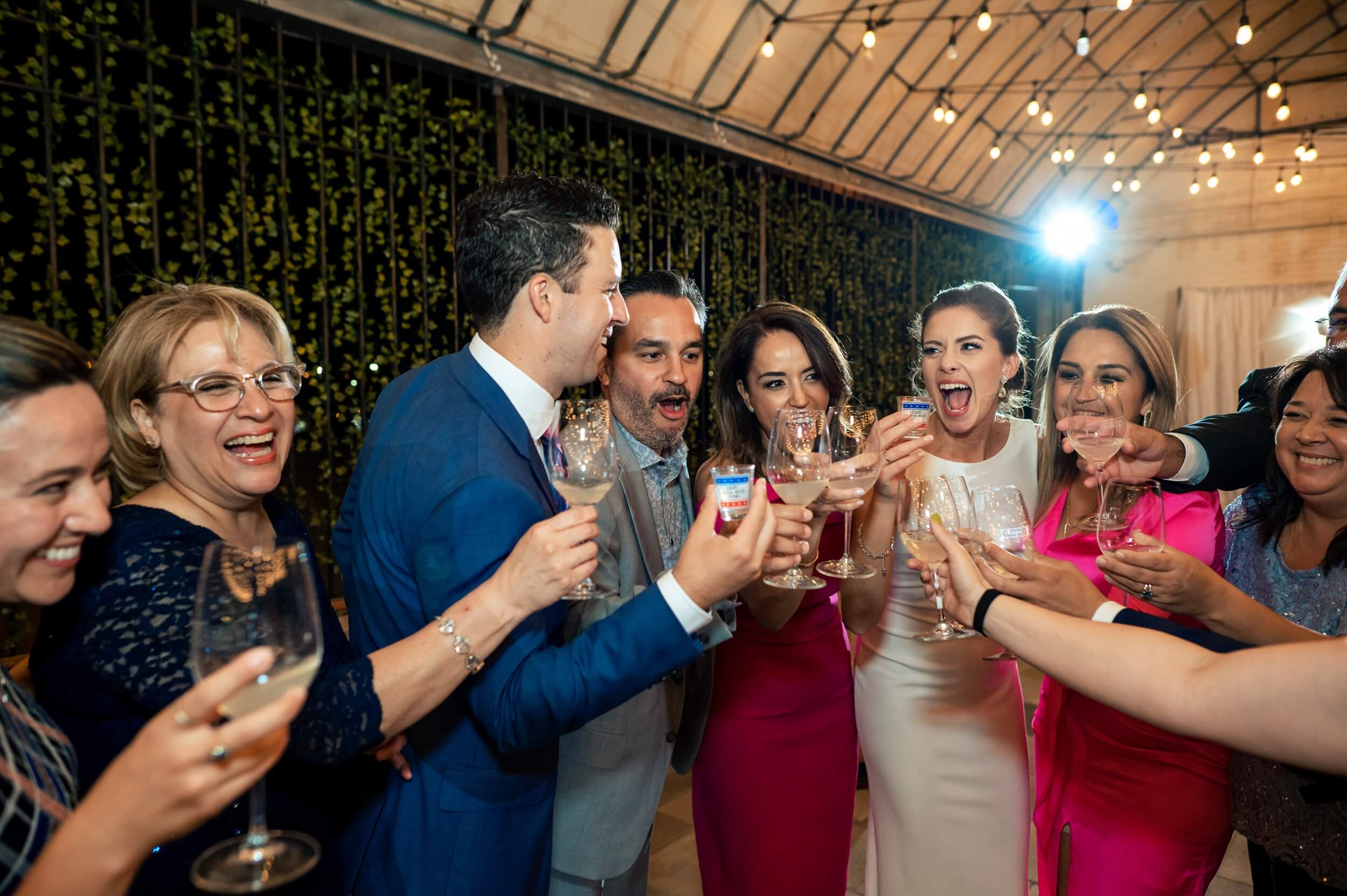 group of friends toasting shots during reception of dc wedding