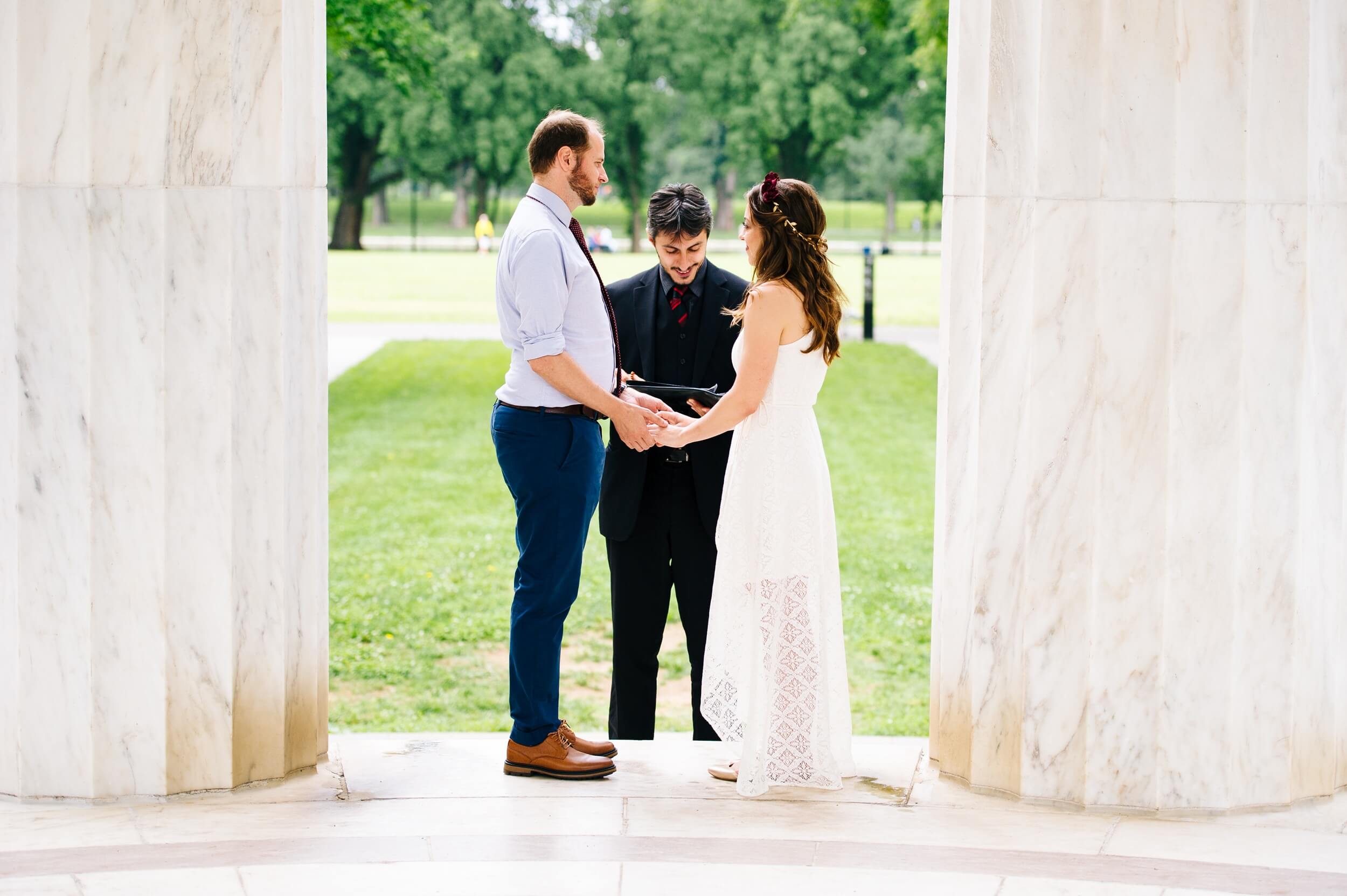bride and groom holding hands exchanging vows at the dc war memorial