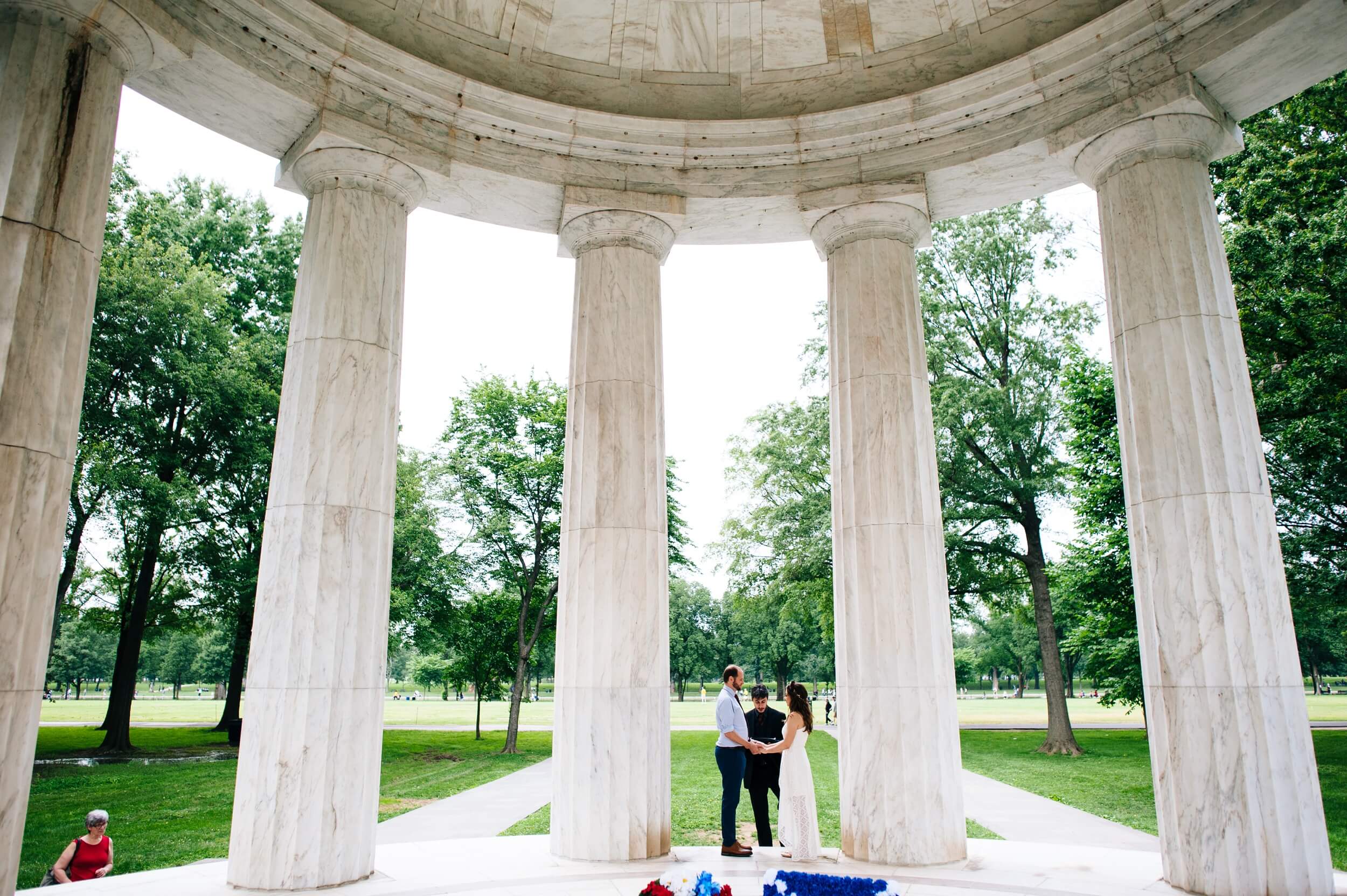 wide angle photo of bride and groom exchanging vows at the dc war memorial