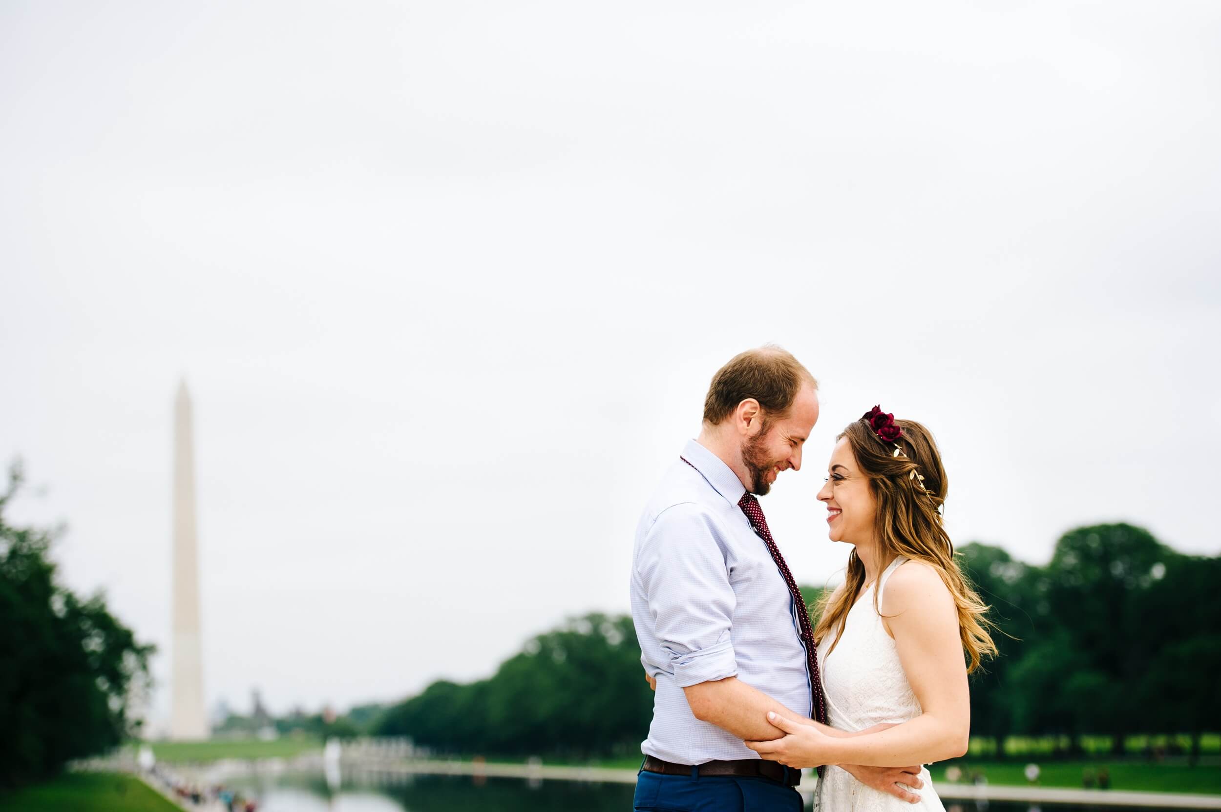 hugging bride and groom with the washington memorial in the background